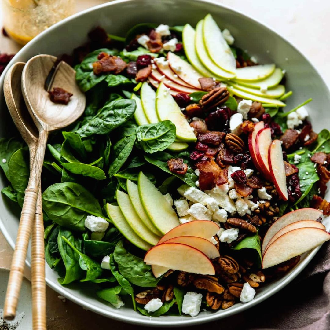 This easy to make Winter Apple Salad is loaded up with crispy bacon, crunchy pecan halves, crumbled feta, and sweet dried cranberries. All drizzled with a homemade maple Dijon vinaigrette.